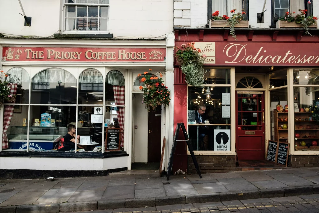 two shops in a small town with decorative flowers on them