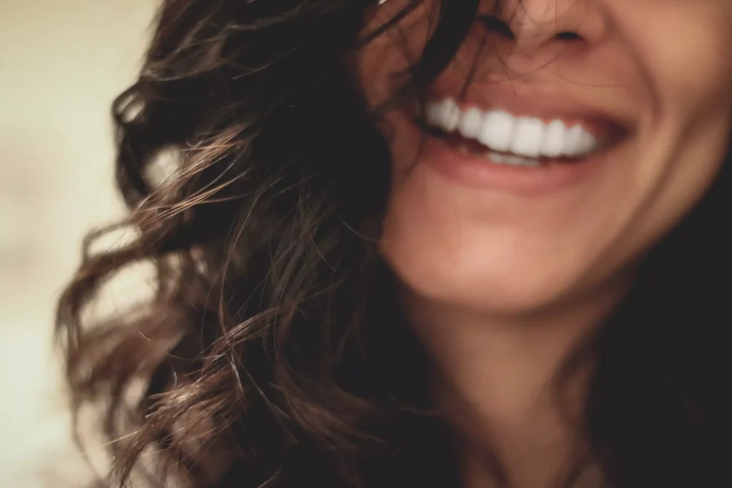 a girl with brown hair smiling