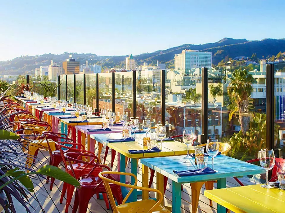 restaurant with colorful tables and chairs on a rooftop