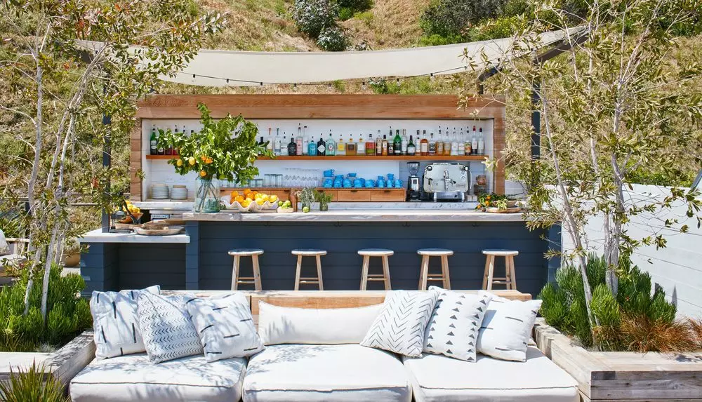 outside bar with white pillows and wooden details