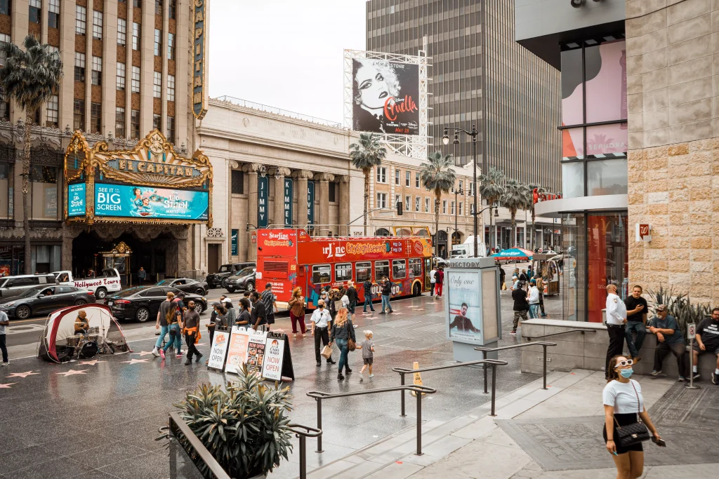 a street in a city with a lot of people and attractions