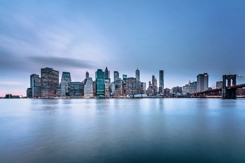 a city with big buildings photographed from the river