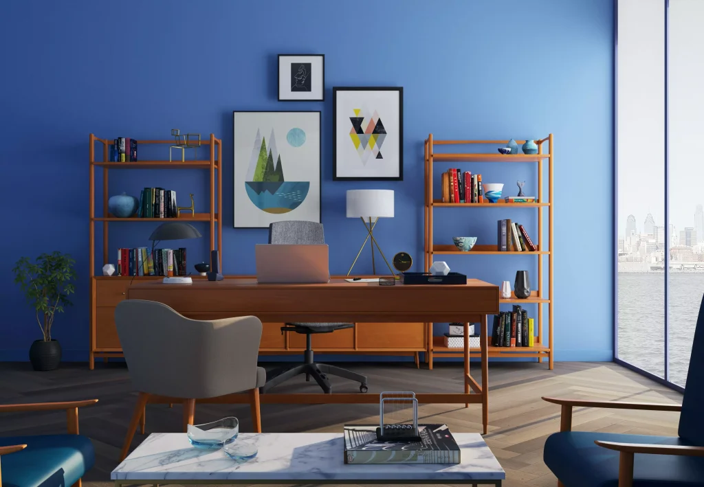 a brown office table and office chair infront of a blue wall