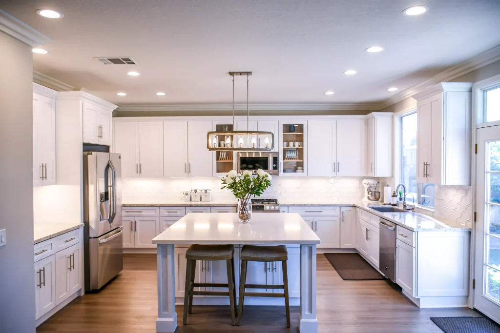 a white colored kitchen with a lot of lights