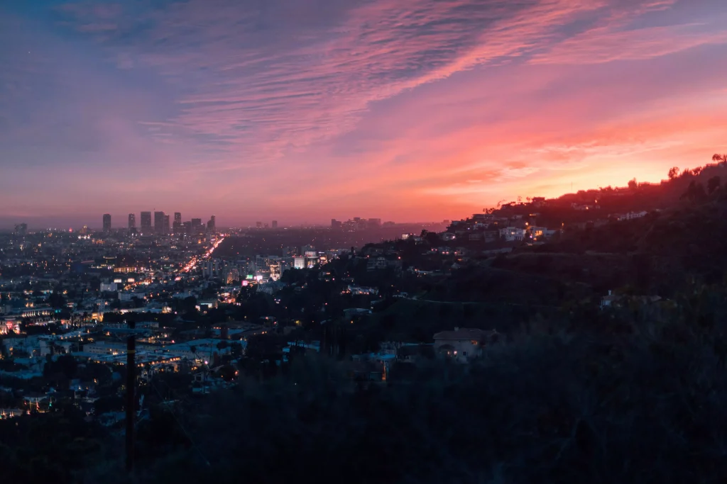 a pink sky photographed from a hill