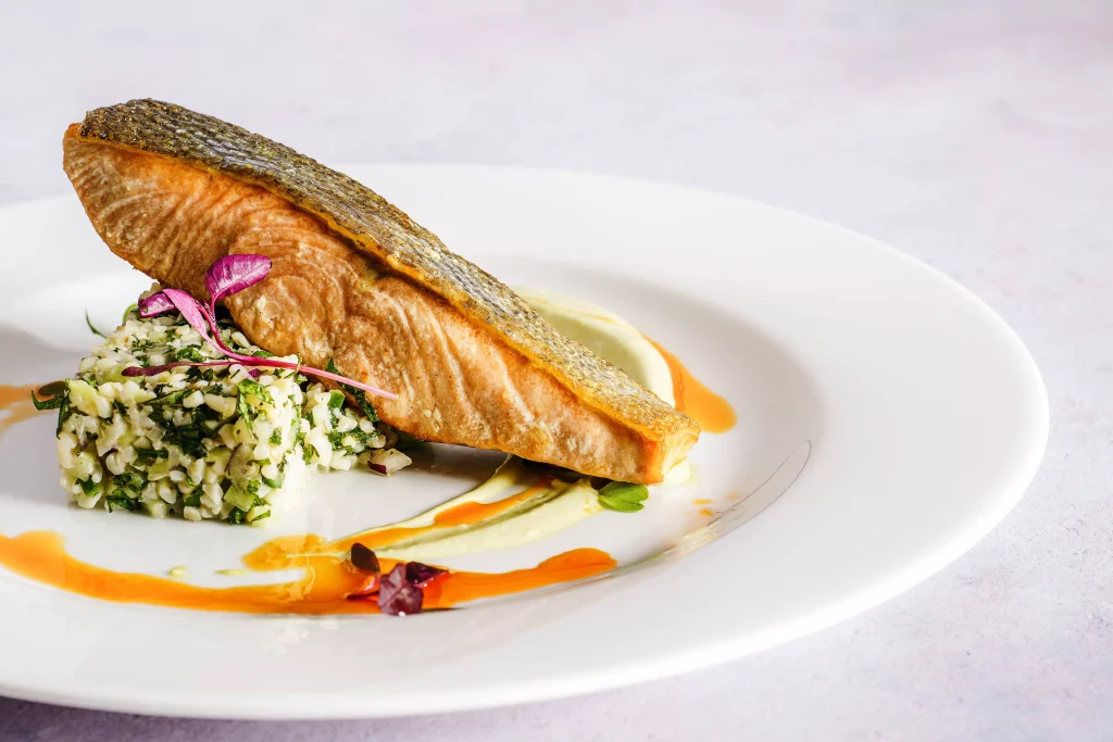 grilled salmon on a white porculan plate served in a restaurant 