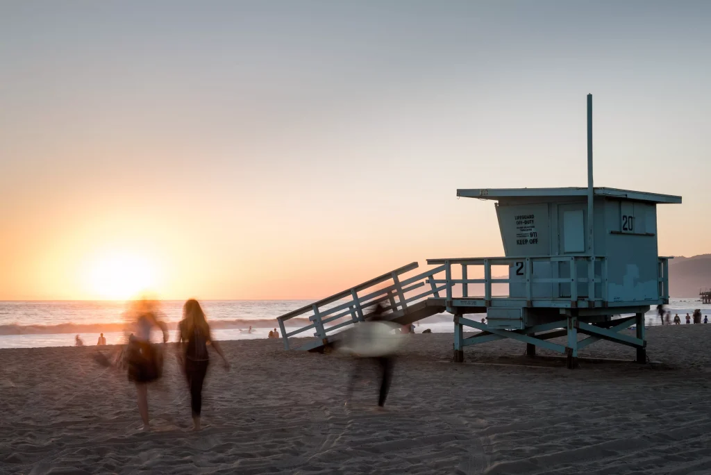 a beach house with people walking past it