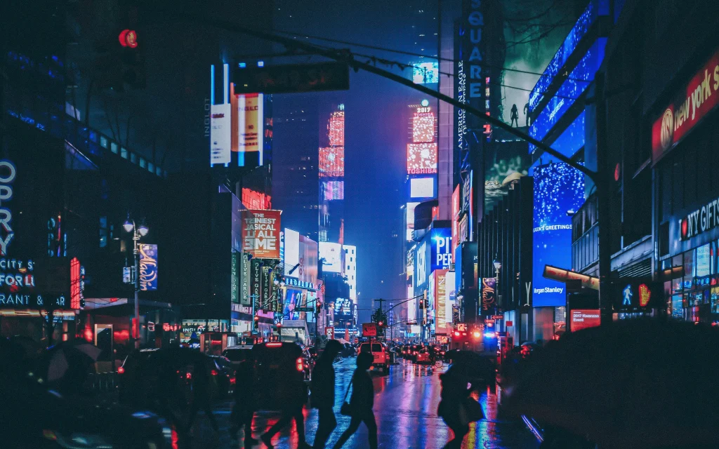 people walking on a street with a lot of lights