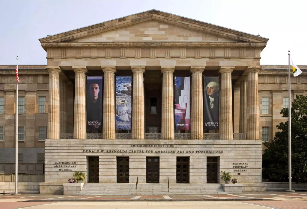 a big yellowish building with posters on it