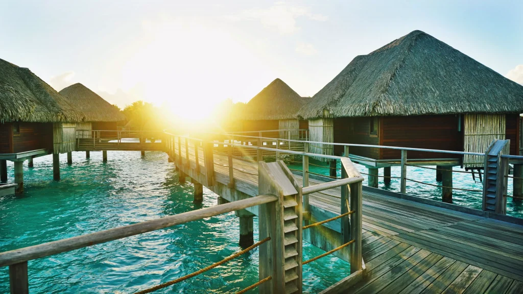 wood houses with bridges coneccting them in the sea