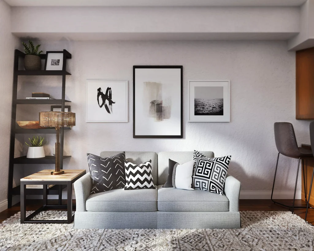 a little light blue couch with black and white pillows on it