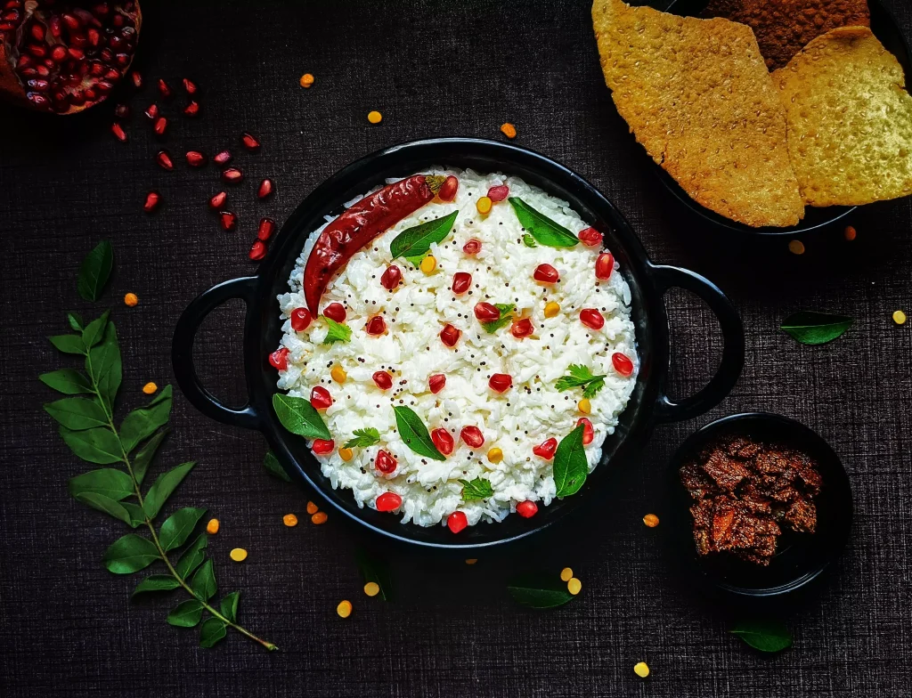 white and red food in a black color pan