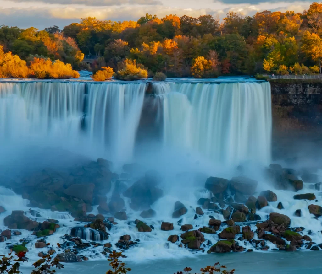 big waterfalls on a river with big rocks in the bottom