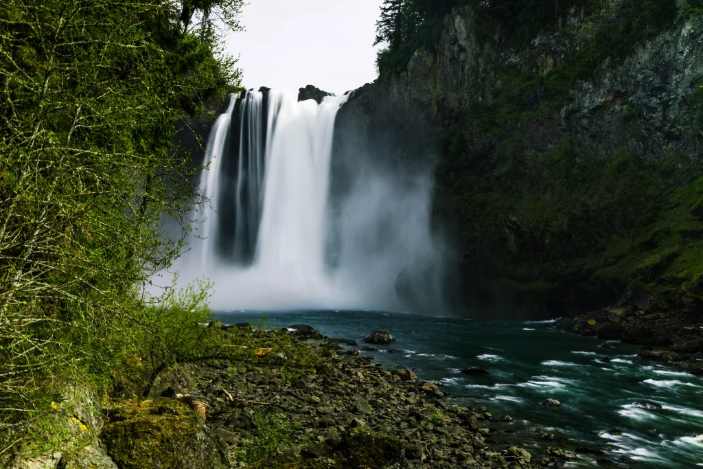 A waterfall of clear water in a green forest