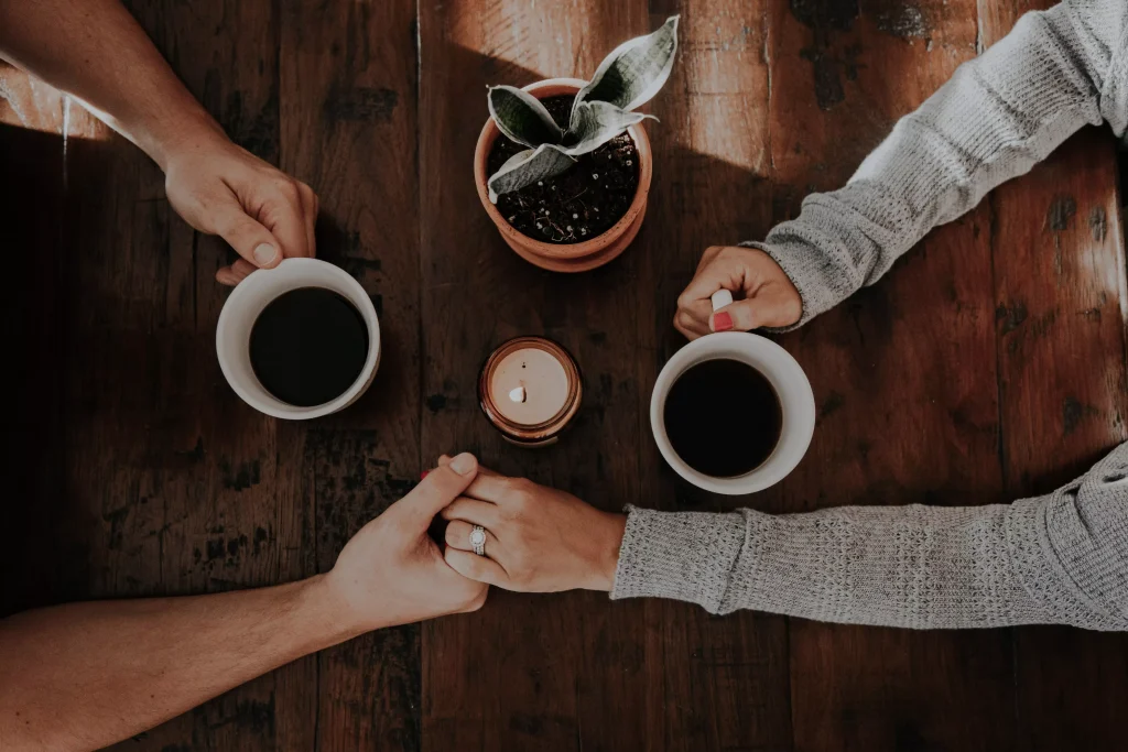 tea and hands holding each other on a table