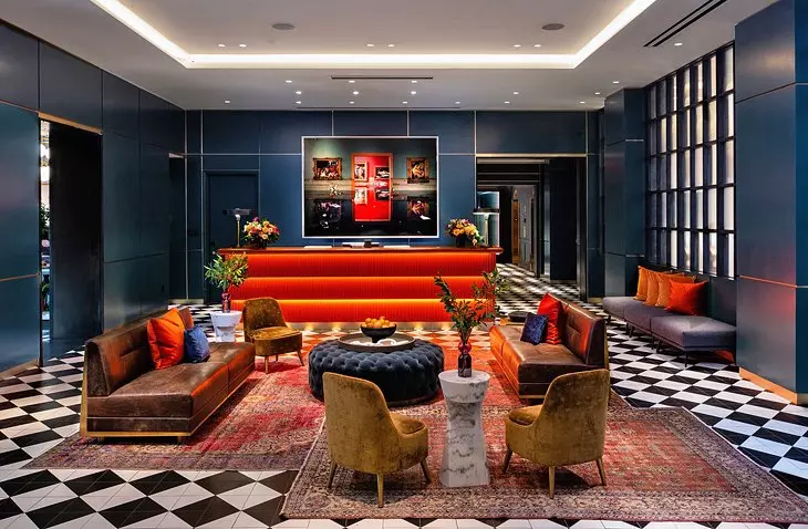 modern looking living room with blue walls and red and brown furniture