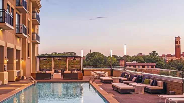 a pool behind a yellow house