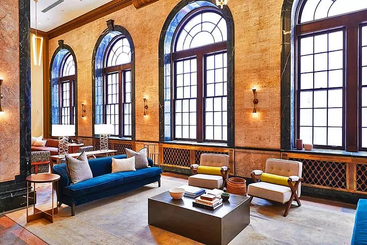 living room with blue furniture and big windows