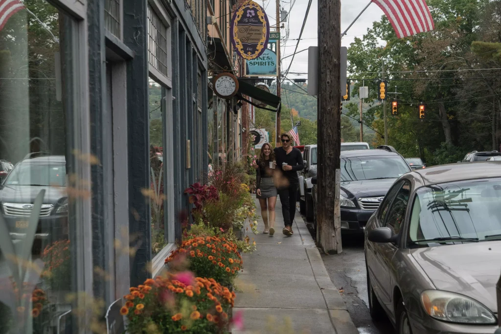 a guy and a girl walking on a sidewalk