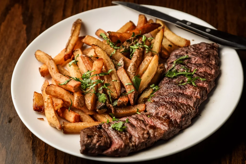 steak and fries in a white porculan plate