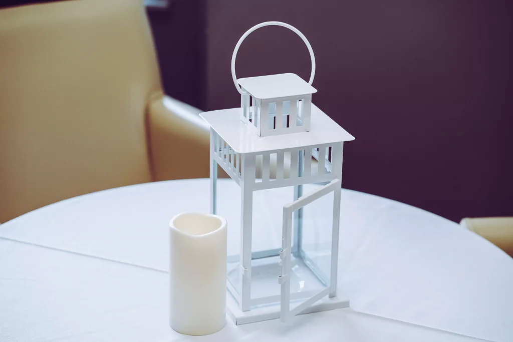 a candle on a table with white cloth