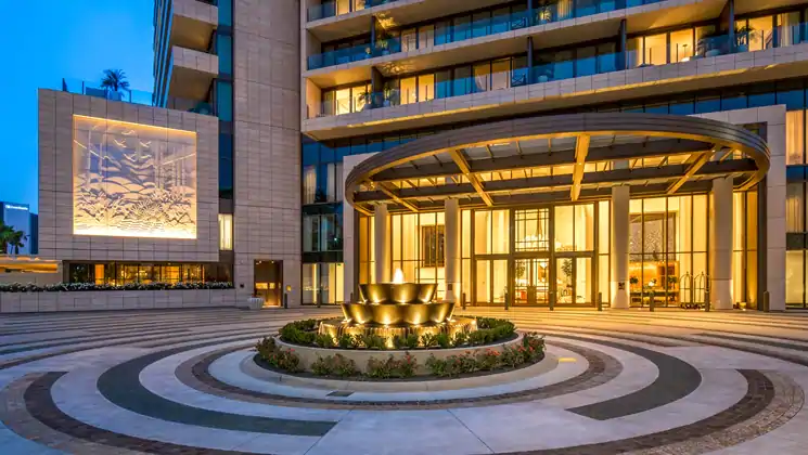 a circle shaped water fountain infront of a building