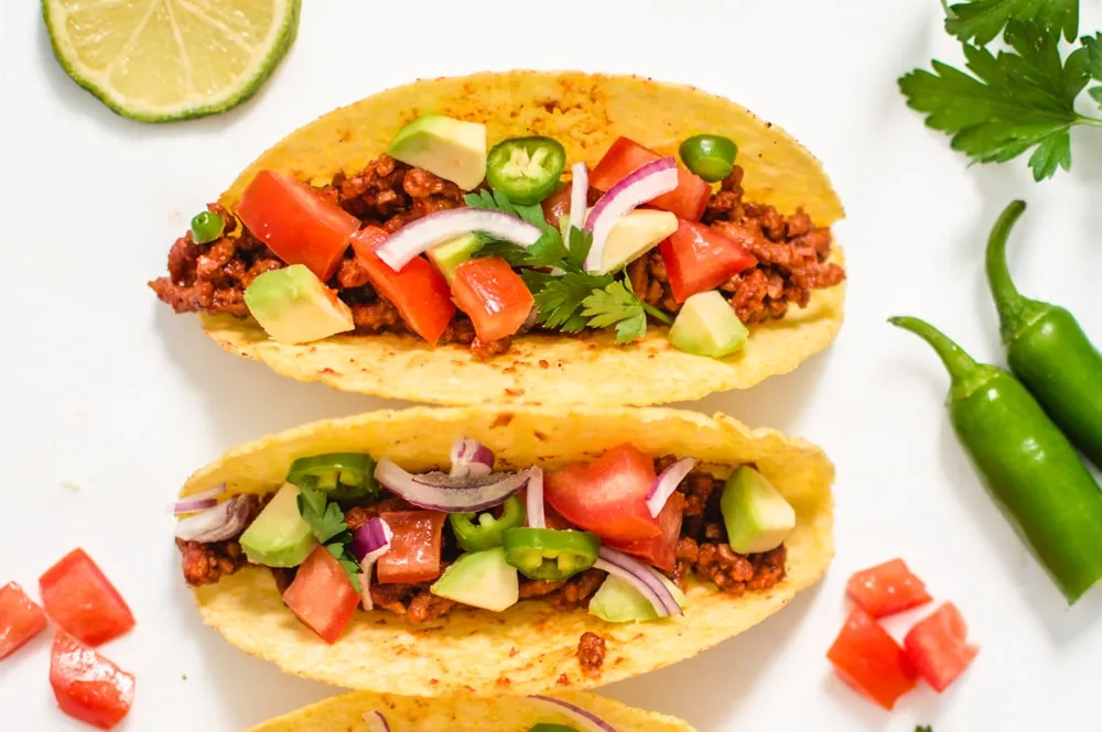 tacos with tomatoes and onions in them