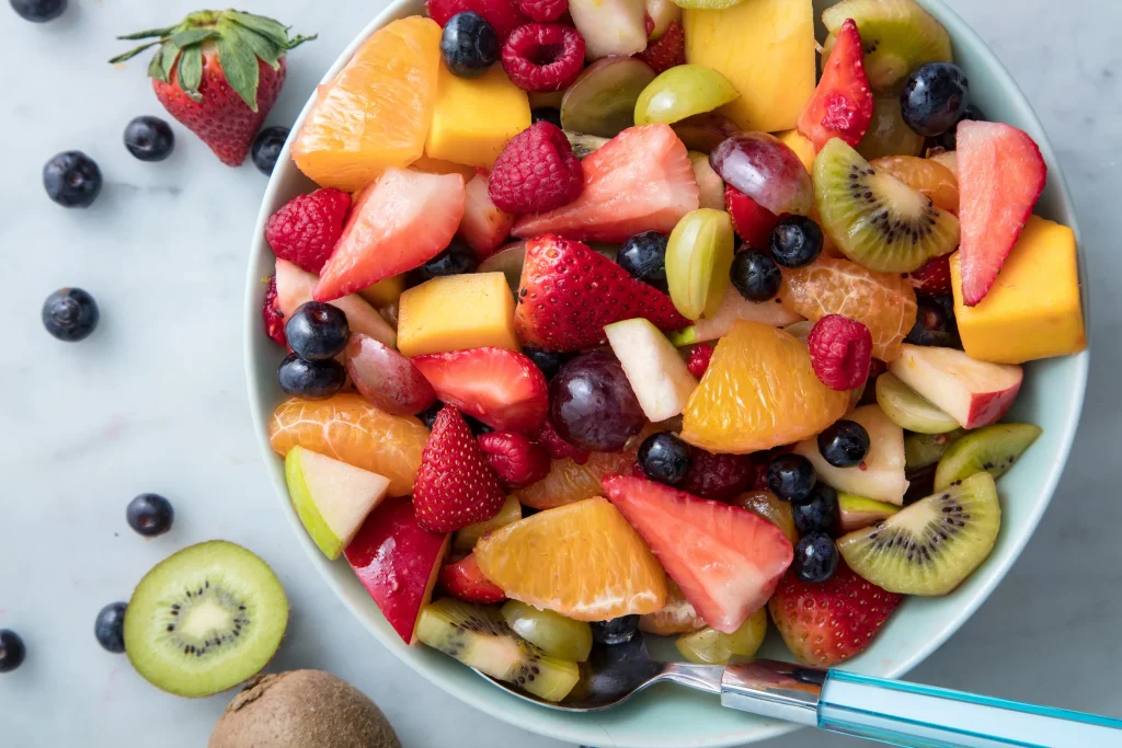 a bowl full of kiwi and strawberrys