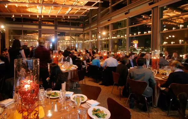 people eating in a restaurant with big windows