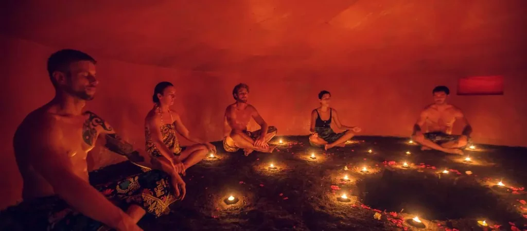 people sitting together in a orange cave