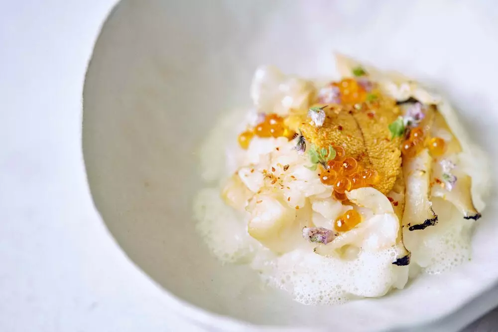 a white porculan bowl with small amounts of food in it