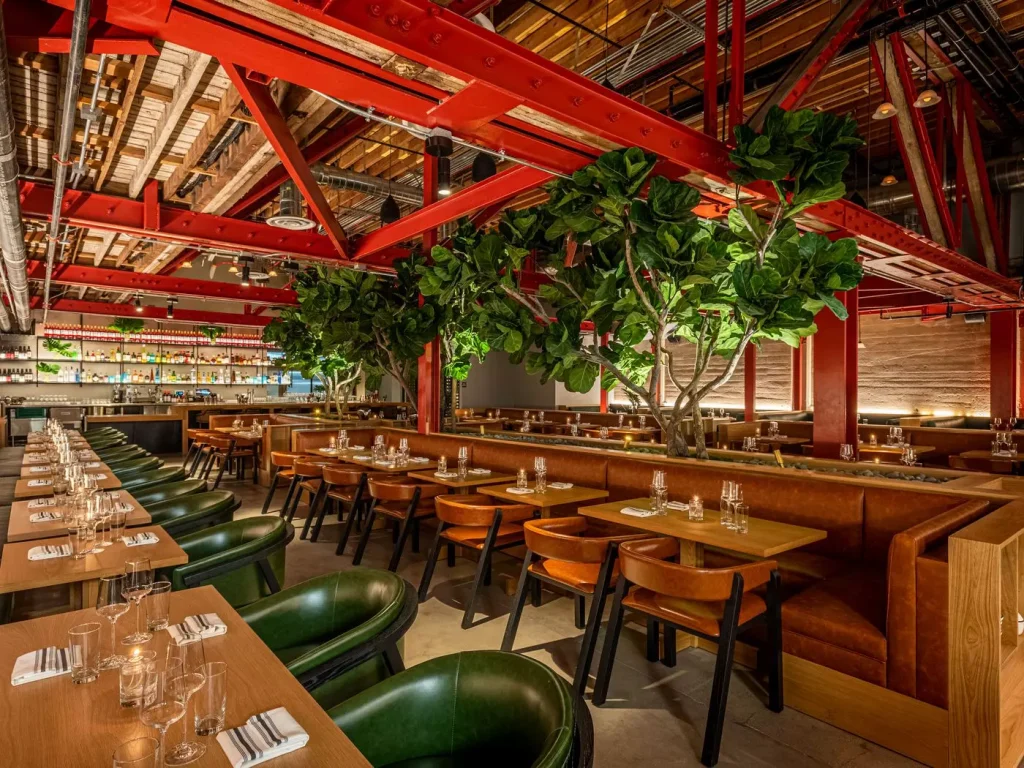 red ceilling in a restaurant with green chairs and brown tables