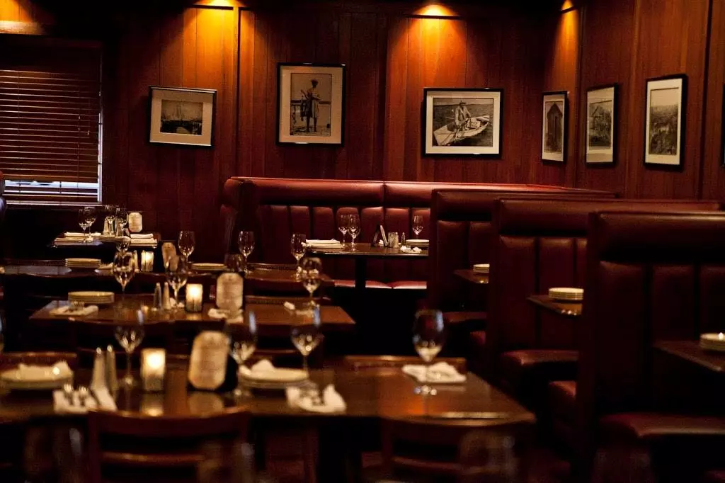 a restaurant with wooden tables and chairs