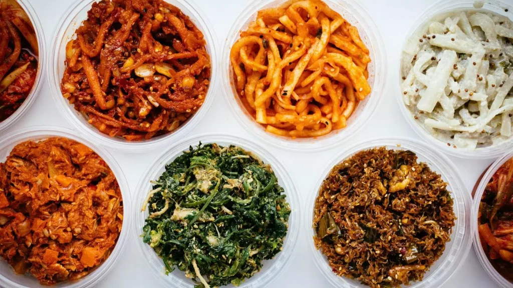 different types of foods in bowls on a table with white cloth