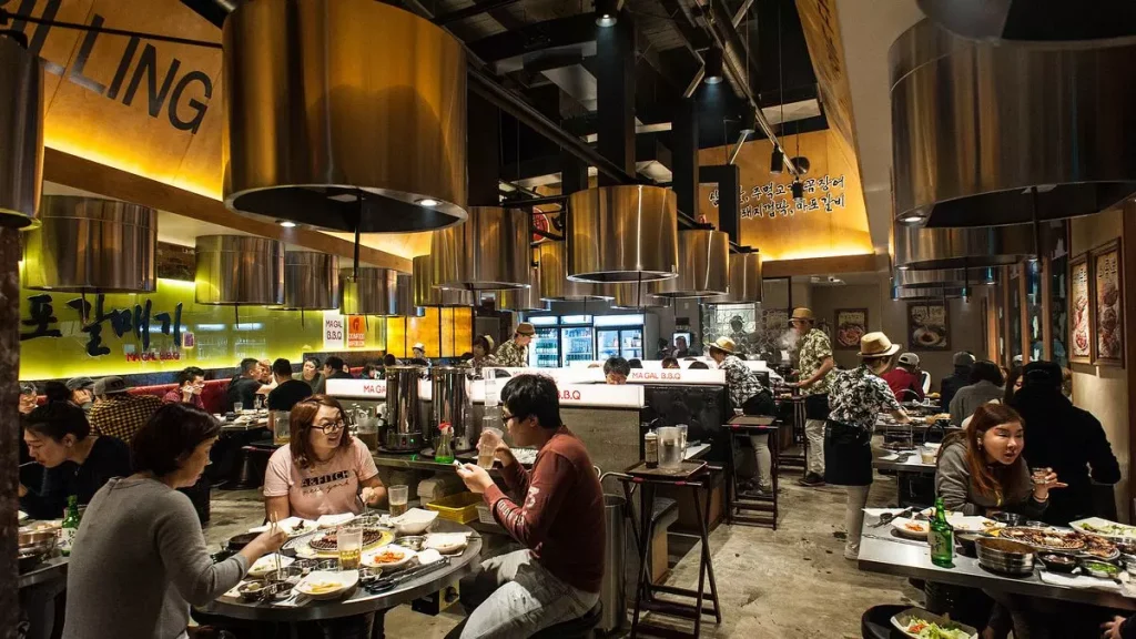 people eating at a restaurant with yellow lights