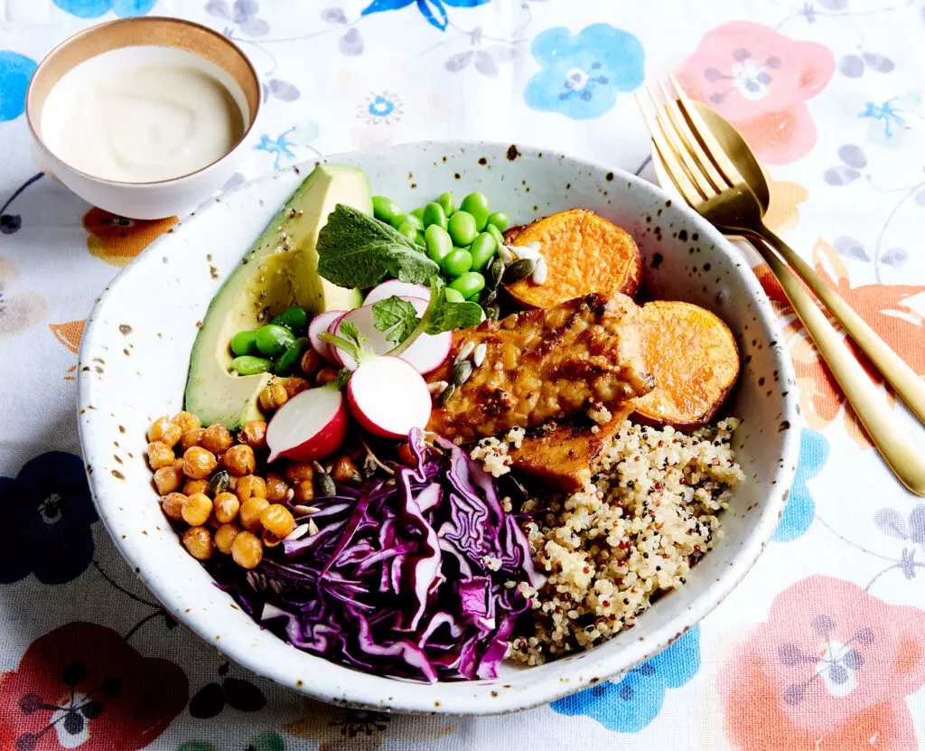 a white porculan bowl full of rice and vegetables