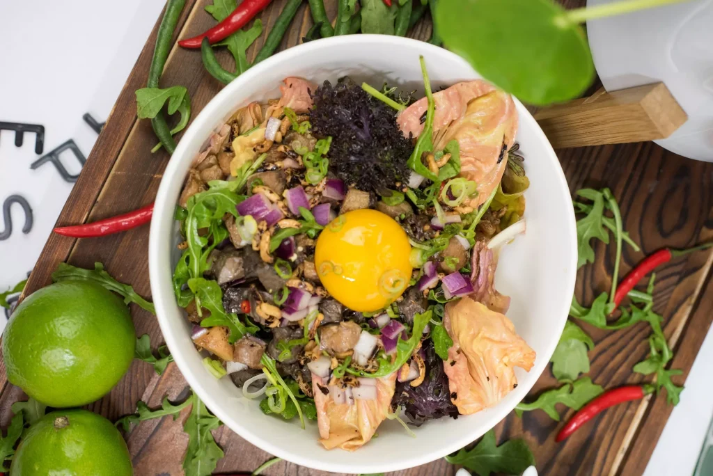 white bowl full of salad on a cutting board