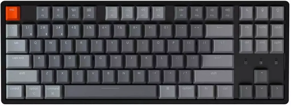 a grey keyboard with one button that is orange