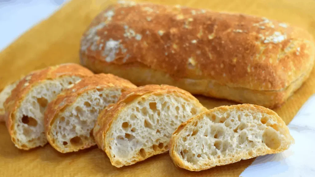 doughy bread placed on a yellow table