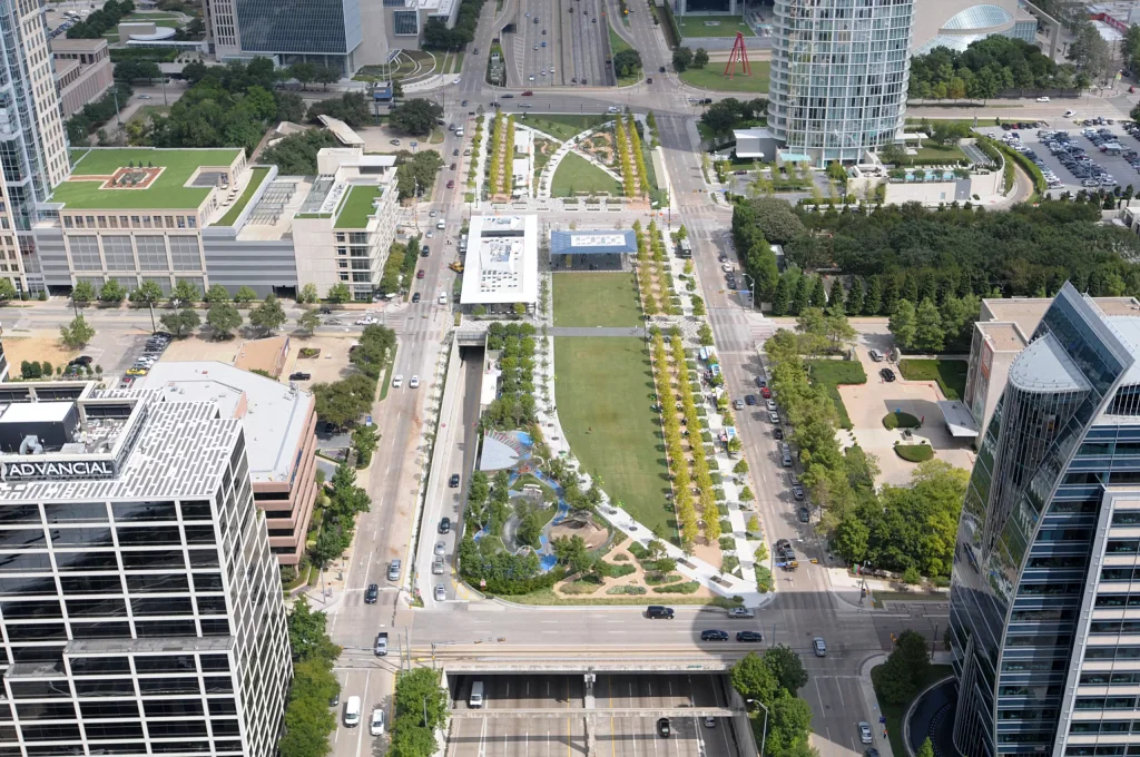 a green field park in the middle of skyscrapers