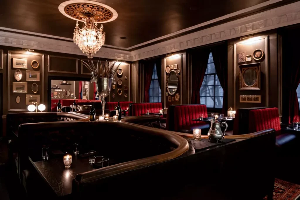 a luxury restaurant with red furniture and big windows photographed from inside