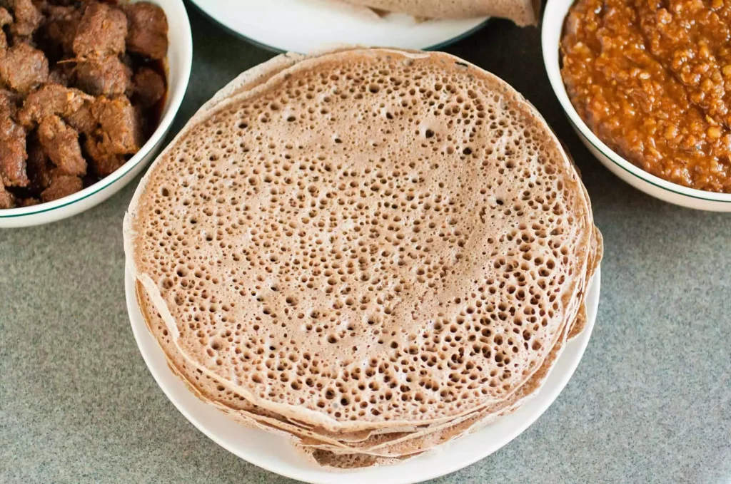 pancakes next to beans and other foods on a table