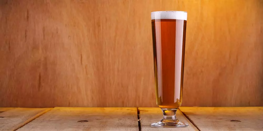 a full glass of beer on a table