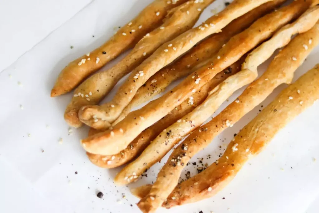 little bread sticks placed on a table