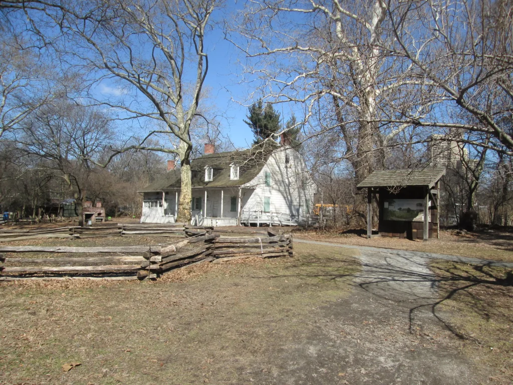 a white color country house with a small little wooden house next to it