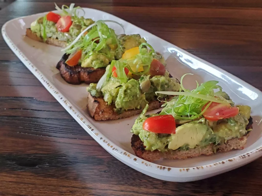 salad and condoments on bread slices on a white porculan plate