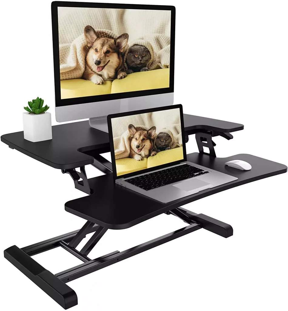 a desk with a monitor and a laptop on it