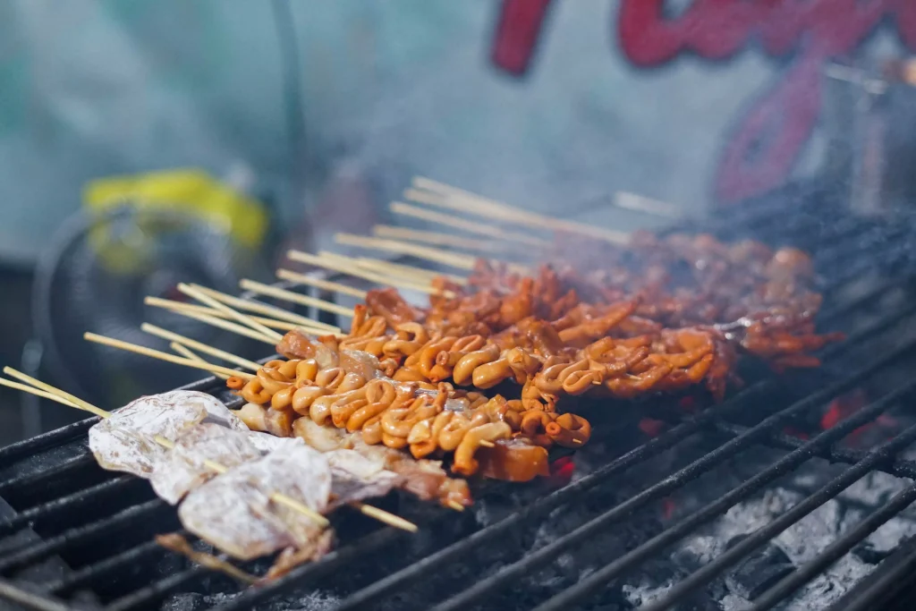 meat on sticks on a grill