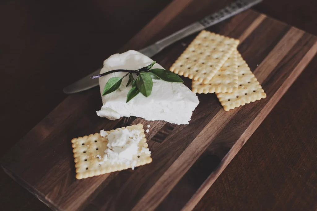 cheese with a green salad on top of it