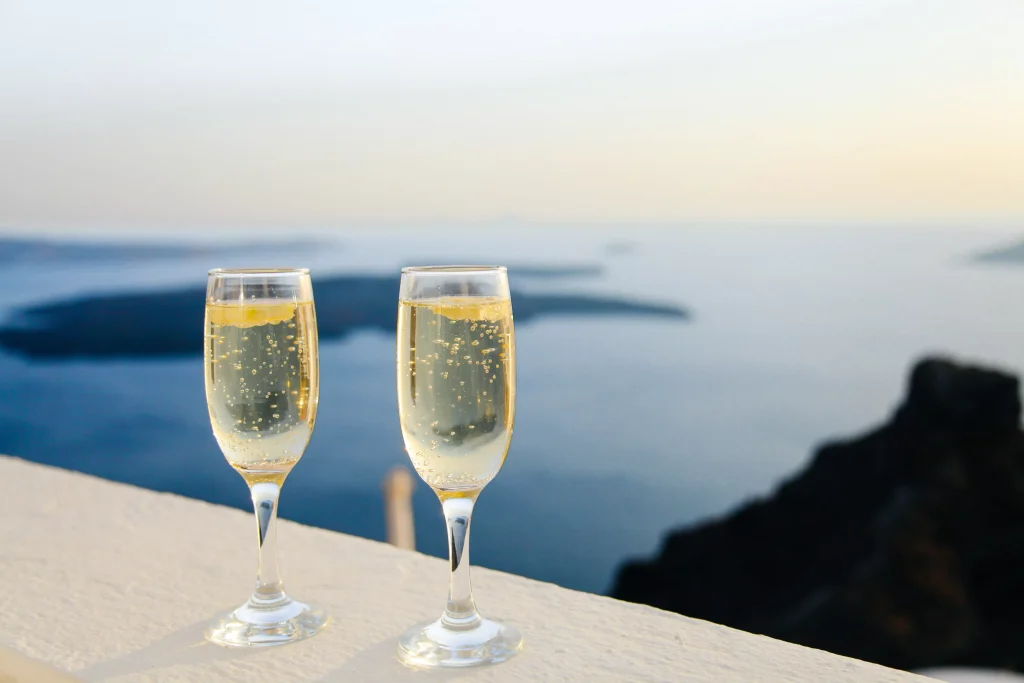 two glasses of lemonade on a balcony overlooking the sea